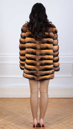 Load image into Gallery viewer, Chinchilla fur coat in a gold tone seen from the back

