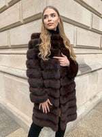 Load image into Gallery viewer, Woman wearing a sable coat with leather inlays between fur
