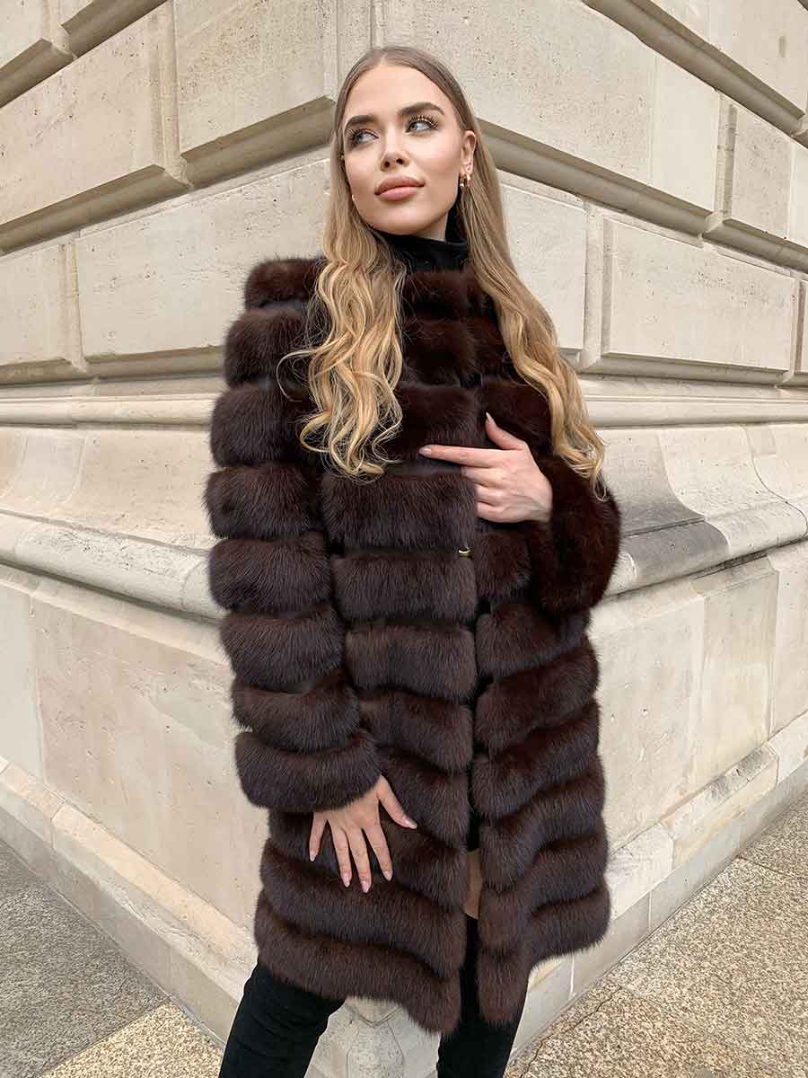 Woman wearing a sable coat with leather inlays between fur