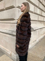 Load image into Gallery viewer, Sable coat with leather inlays between fur seen from the side
