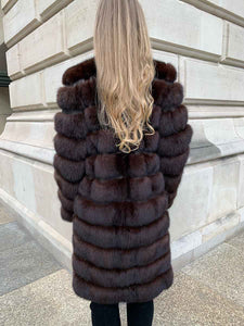 Sable coat with leather inlays between fur seen from the back
